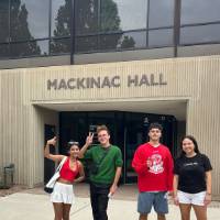 Students posing for a picture by Mackinac Hall at GVSU during orientation (2)